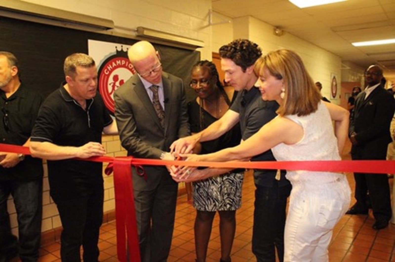Pastor Keenann Knox cutting the ribbon at the July 2016 Champions Club opening, joined by Joel and Victoria Osteen and church leaders
