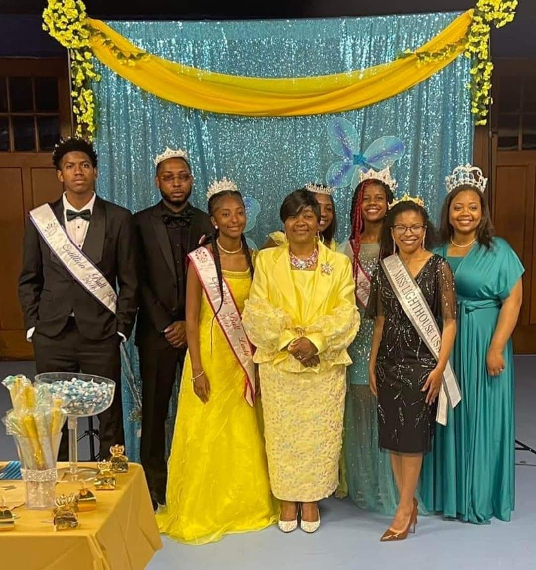 Cotillion young ladies and gentlemen in crowns and sashes with their sponsors