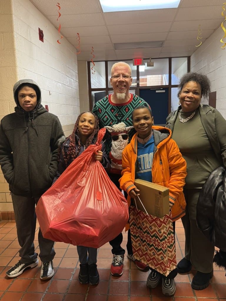 Pastor Knox with a Detroit family receiving gifts through Hope 4 the Holidays