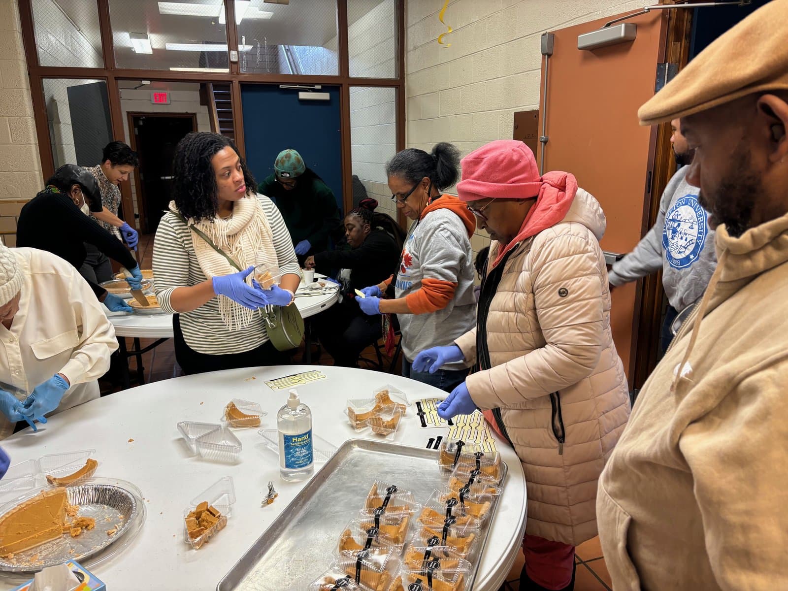 Volunteers serving plates of food to Detroit neighbors at Impact City Church