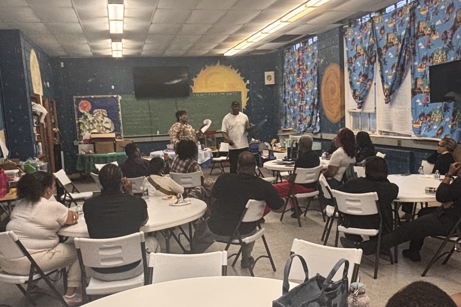 A marriage mentoring session in progress, couples seated at round tables