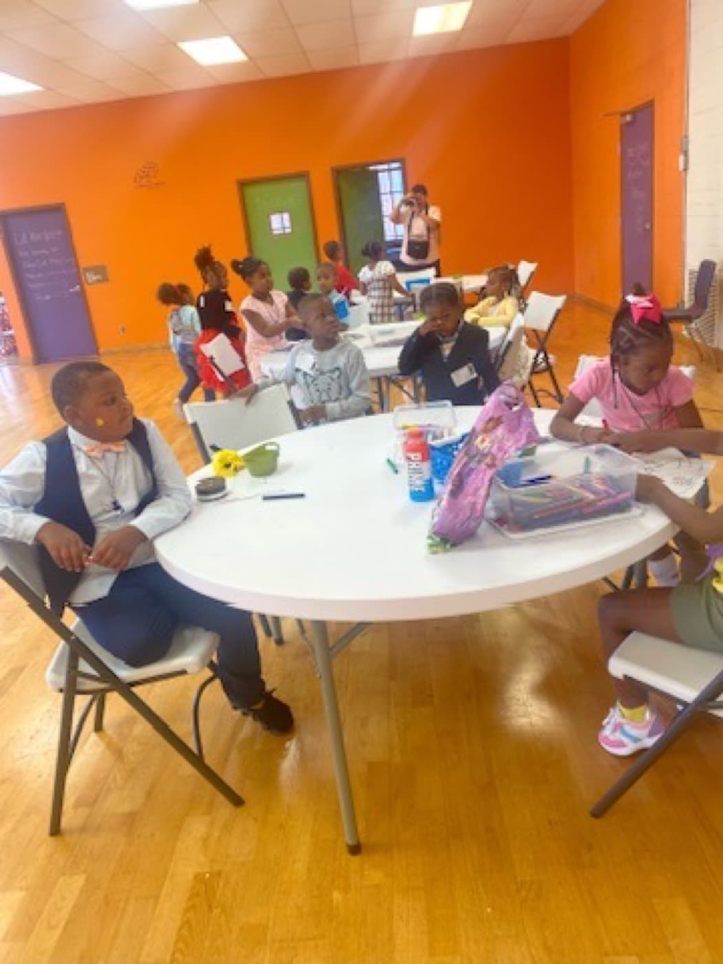 Children at Impact City Church working on a craft together around a table in the iKIDZ room